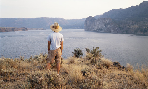 a man looks out over the river